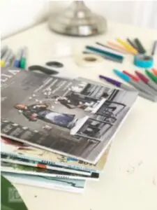 magazines and markers on a desk